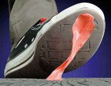 pink gum stuck to the bottom of a sneaker